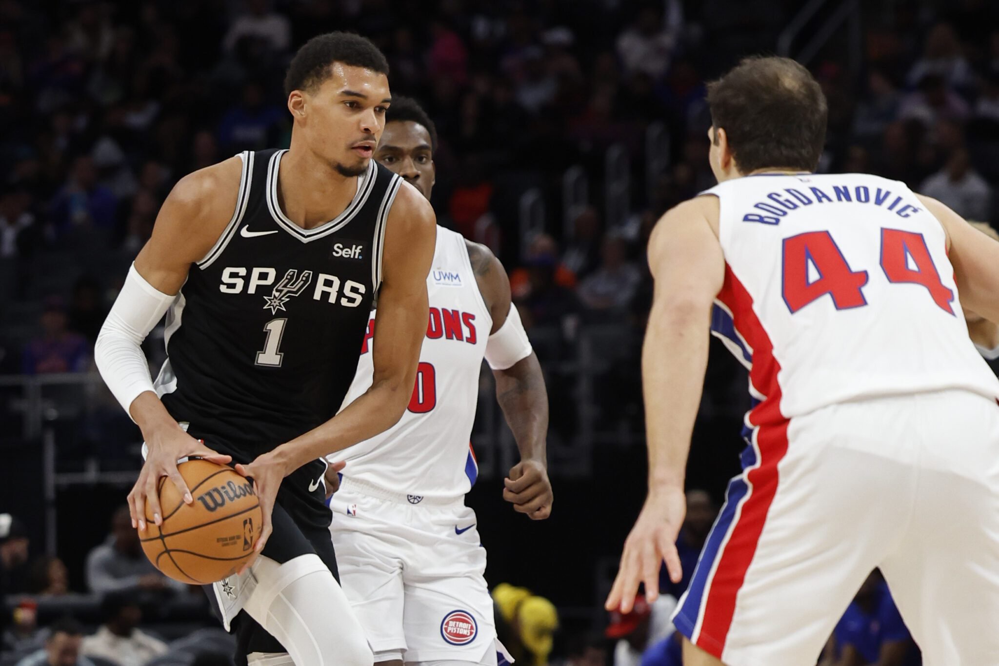Jan 10, 2024; Detroit, Michigan, USA; San Antonio Spurs center Victor Wembanyama (1) dribbles defended by Detroit Pistons forward Bojan Bogdanovic (44) in the first half at Little Caesars Arena. Mandatory Credit: Rick Osentoski-USA TODAY Sports