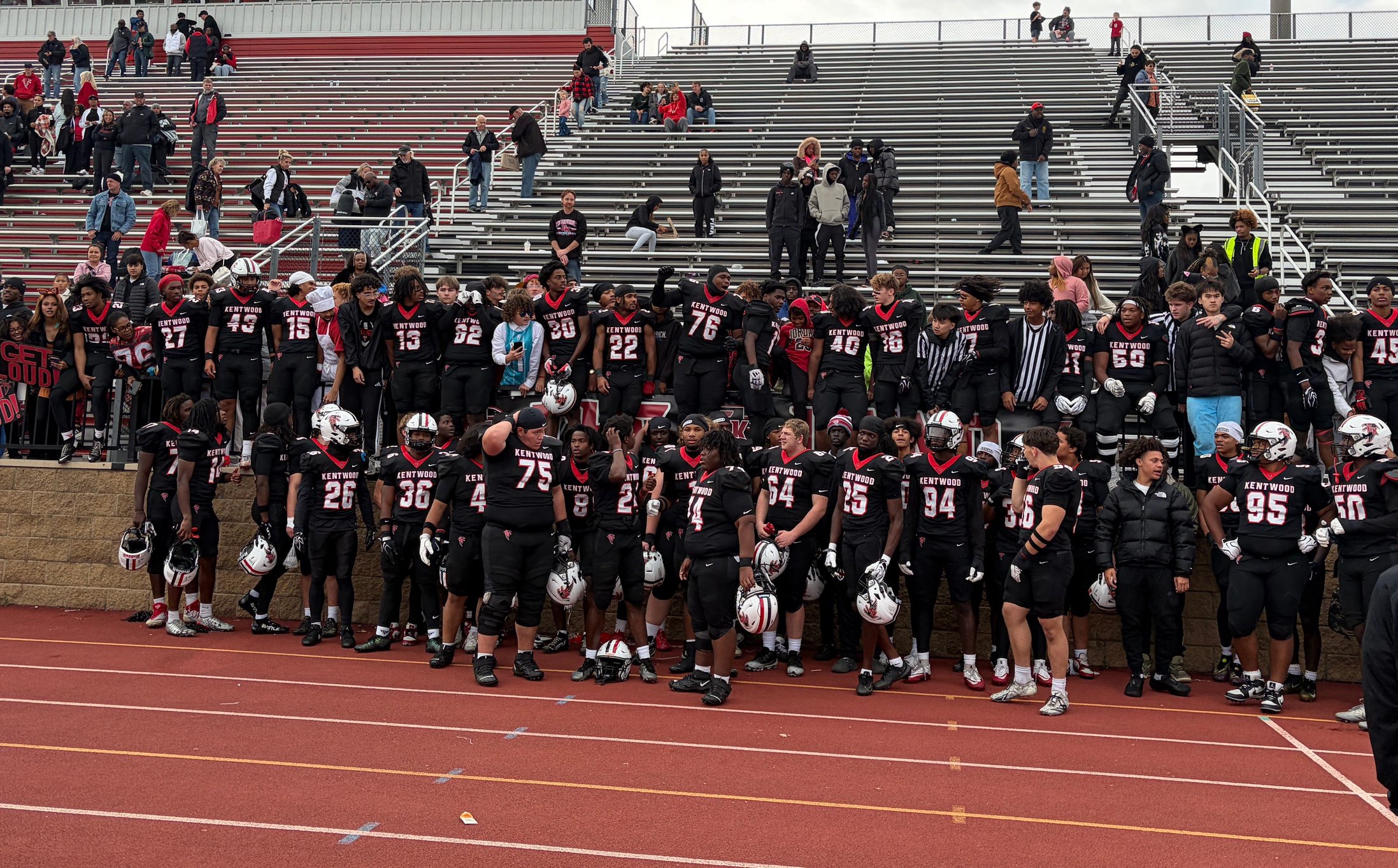 East Kentwood players celebrate a 49-21 win over Brighton in a Division 1 district semifinal on Saturday, Oct. 31.