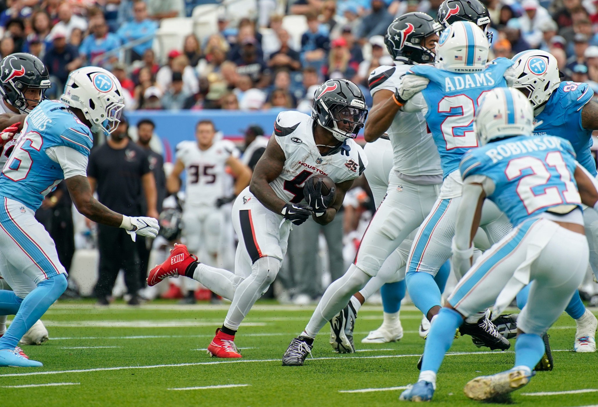 Houston Texans running back Woody Marks (4) breaks for a first down during the third quarter against the Tennessee Titans at Nissan Stadium in Nashville, Tenn., Sunday, Oct. 11, 2026.