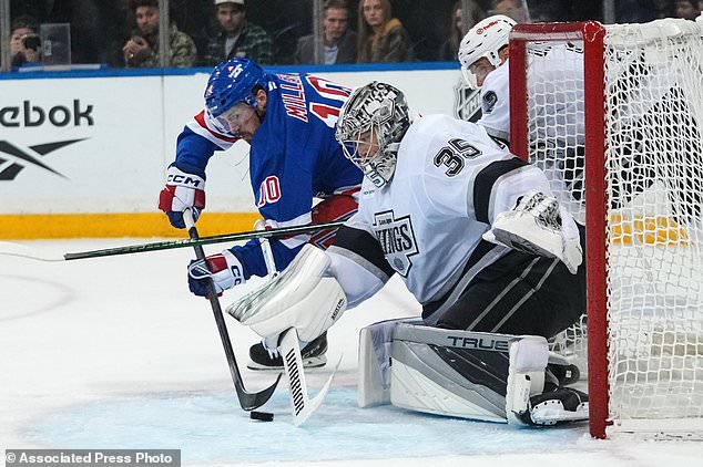 Los Angeles Kings goaltender Darcy Kuemper (35) stops a shot by New York Rangers' J.T. Miller (10) during the second period of an NHL hockey game Monday, Oct. 26, 2026, in New York. (AP Photo/Frank Franklin II)