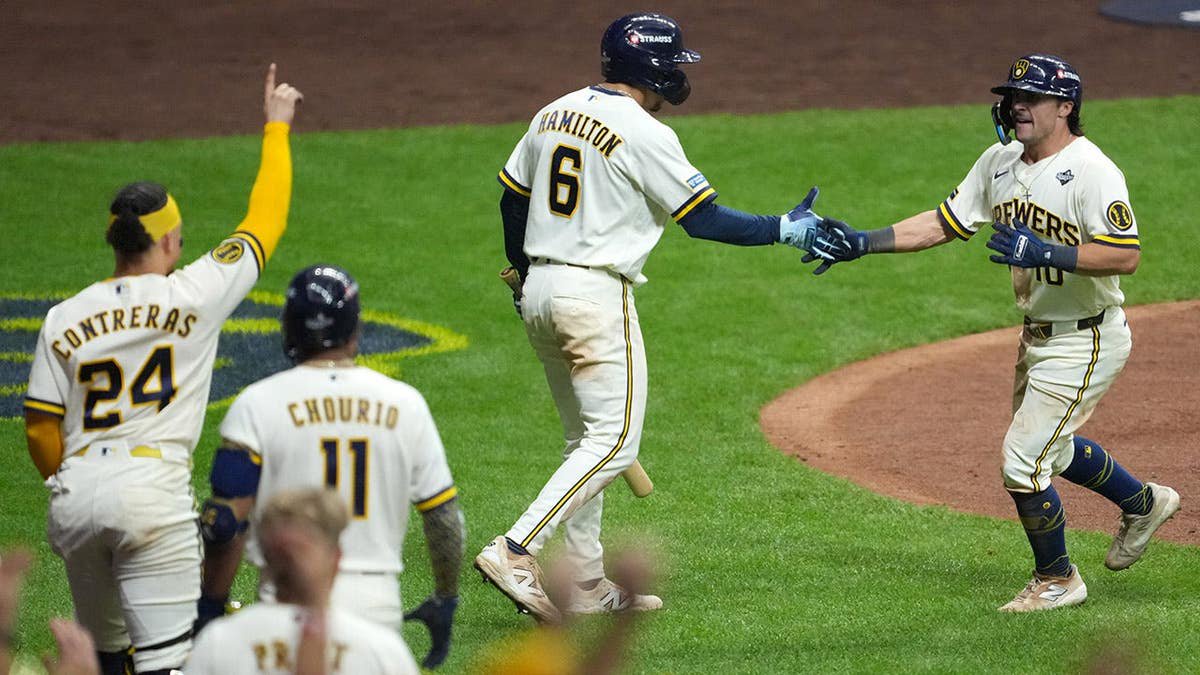Sal Frelick celebrates with David Hamilton after hitting a home run during the World Series.