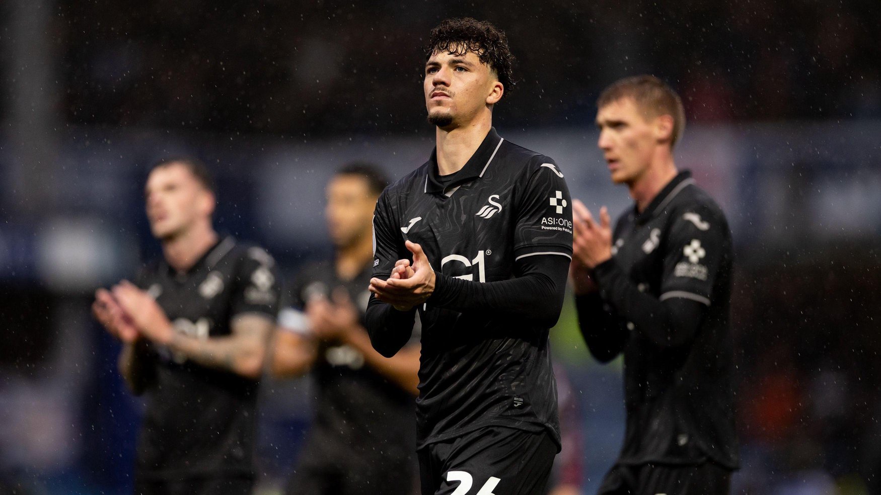 Filip Lissah applauds fans after Swansea's defeat at QPR 