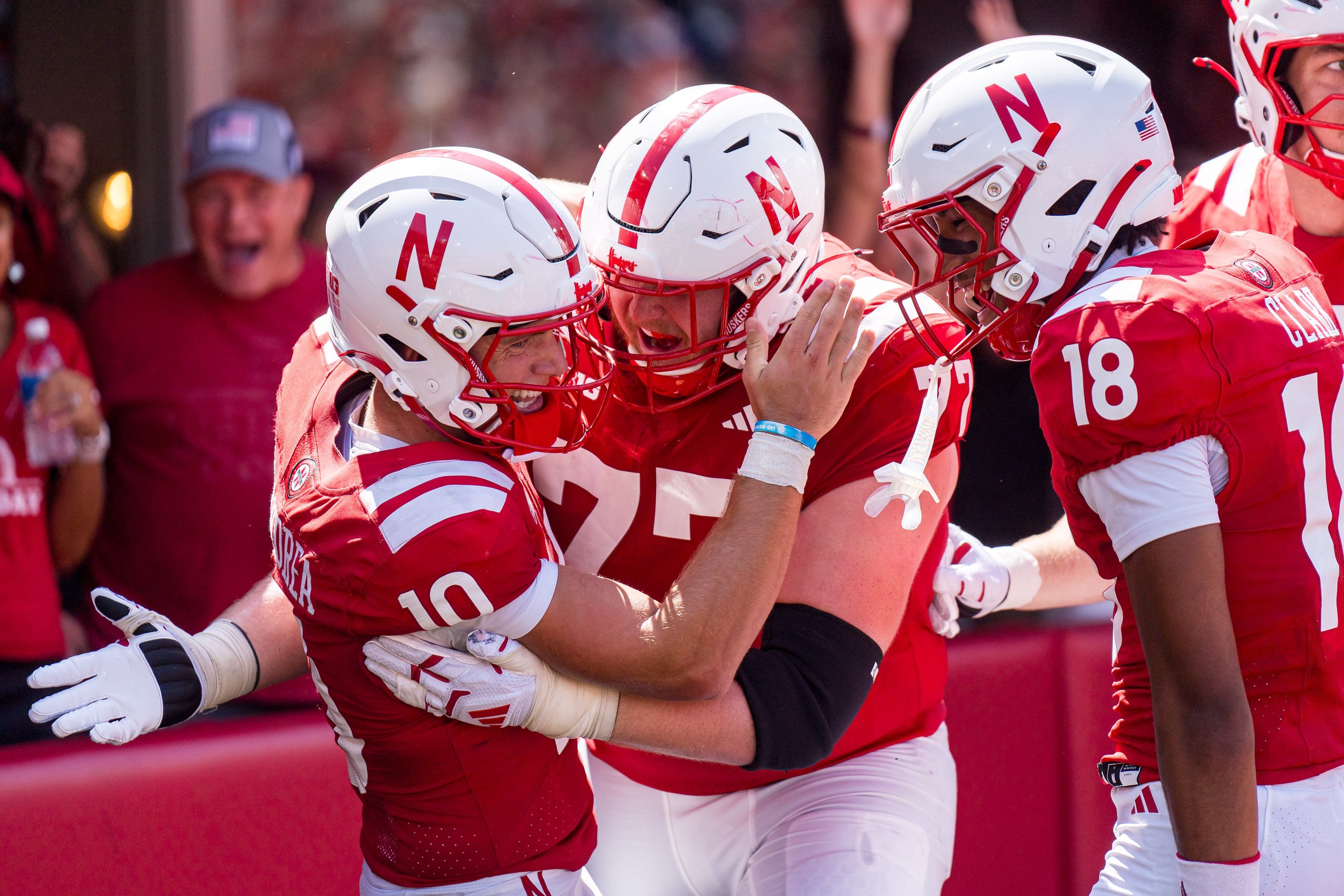 Sep 5, 2026; Lincoln, Nebraska, USA;  Nebraska Cornhuskers quarterback Anthony Colandrea (10) celebrates with offensive lineman Tyler Knaak (75) and wide receiver Quinn Clark (18) after a touchdown in the third quarter against the Ohio Bobcats at Memorial Stadium.  Mandatory Credit: Dylan Widger-Imagn Images