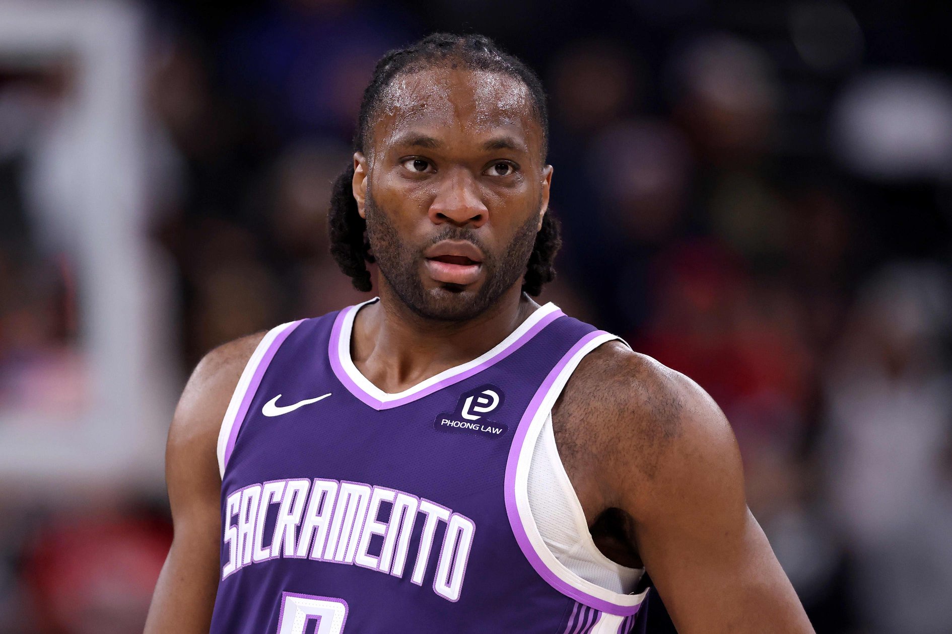 Precious Achiuwa of the Sacramento Kings in a purple jersey looking on during a game.