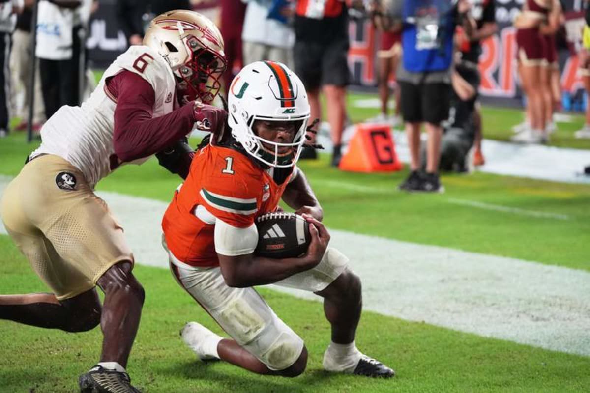 Miami wide receiver Malachi Toney scores a touchdown past Florida State defensive back Ja'bril Rawls during the second overtime Saturday night. ©Lynne Sladky