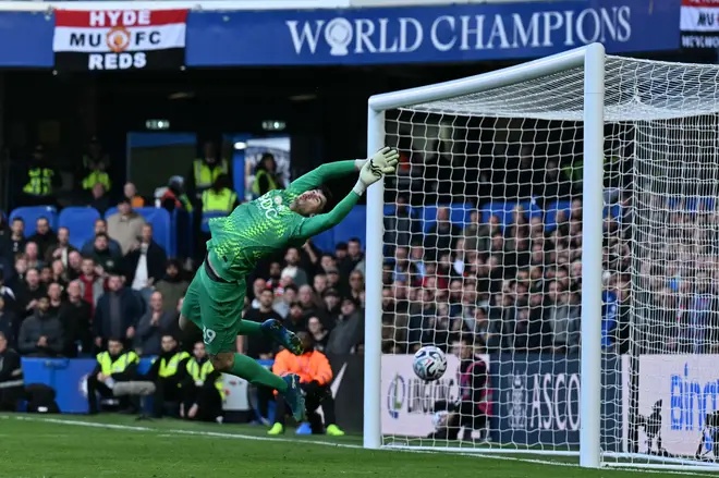 A shot from Manchester United's Cameroonian midfielder Bryan Mbeumo comes back off the crossbar after a save from Chelsea's Belgian goalkeeper Mike Penders