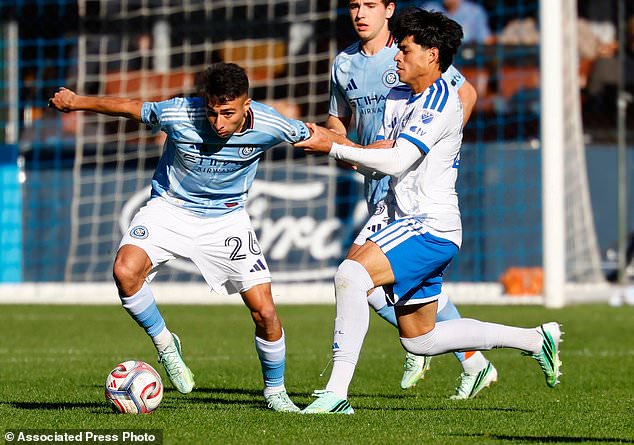 CF Montréal midfielder Olger Escobar, right, holds the arm of New York City FC forward Agustín Ojeda (26) during the second half of an MLS soccer match, Saturday, Oct. 31, 2026, in New York. (AP Photo/Noah K. Murray)