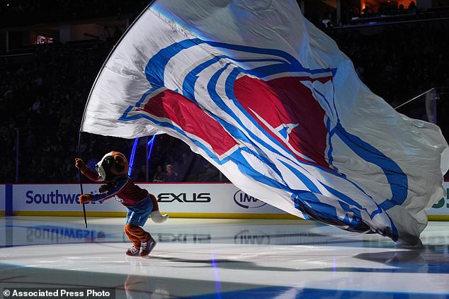 Colorado Avalanche mascot Bernie the St. Bernard carries the team flag before an NHL hockey game against the Tampa Bay Lightning, Friday, Oct. 23, 2026, in Denver. (AP Photo/David Zalubowski)