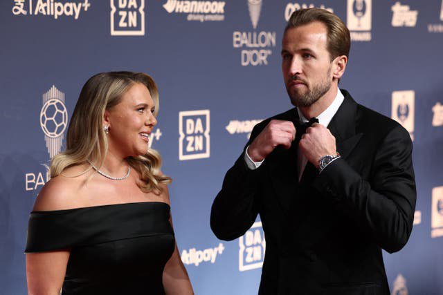 Kane arrives with his wife, Katie Goodland