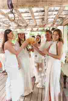 Bridesmaids in Different White Poolside Dresses Having Cocktails 