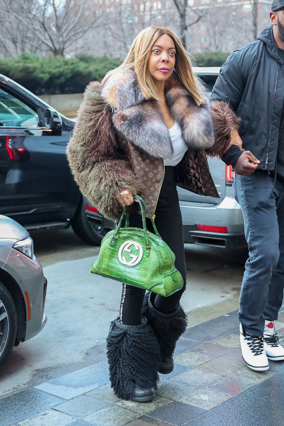 Wendy clung to her security guard's arm while dressed in a head-to-toe designer outfit