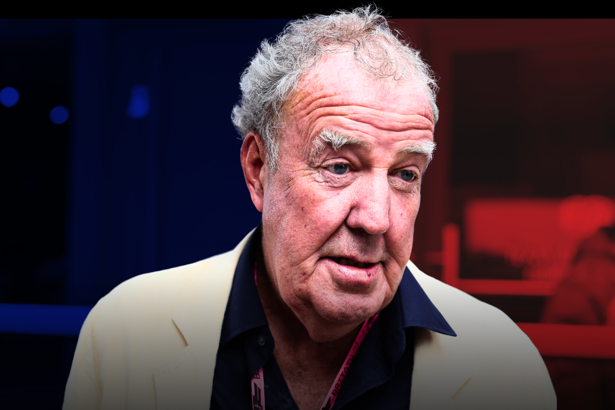 Jeremy Clarkson looking confused with a pink VIP F1 pass round his neck with a blue and red shadow background — Photo: © IMAGO