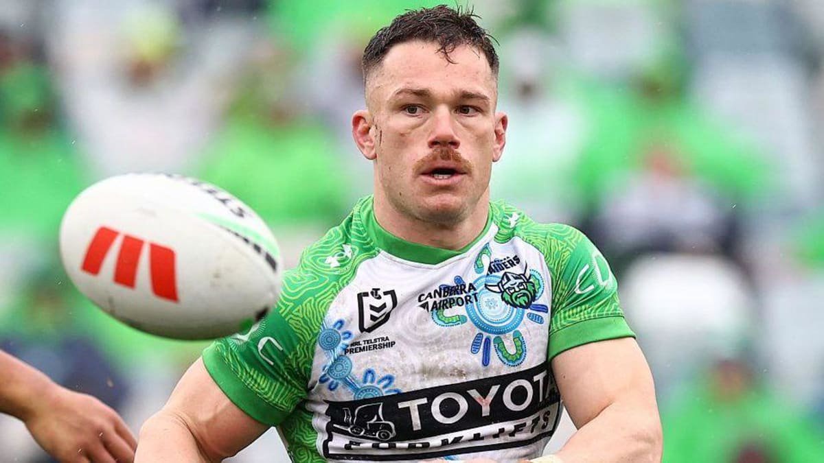 Tom Starling, in Canberra Raiders' white and green shirt, makes a pass