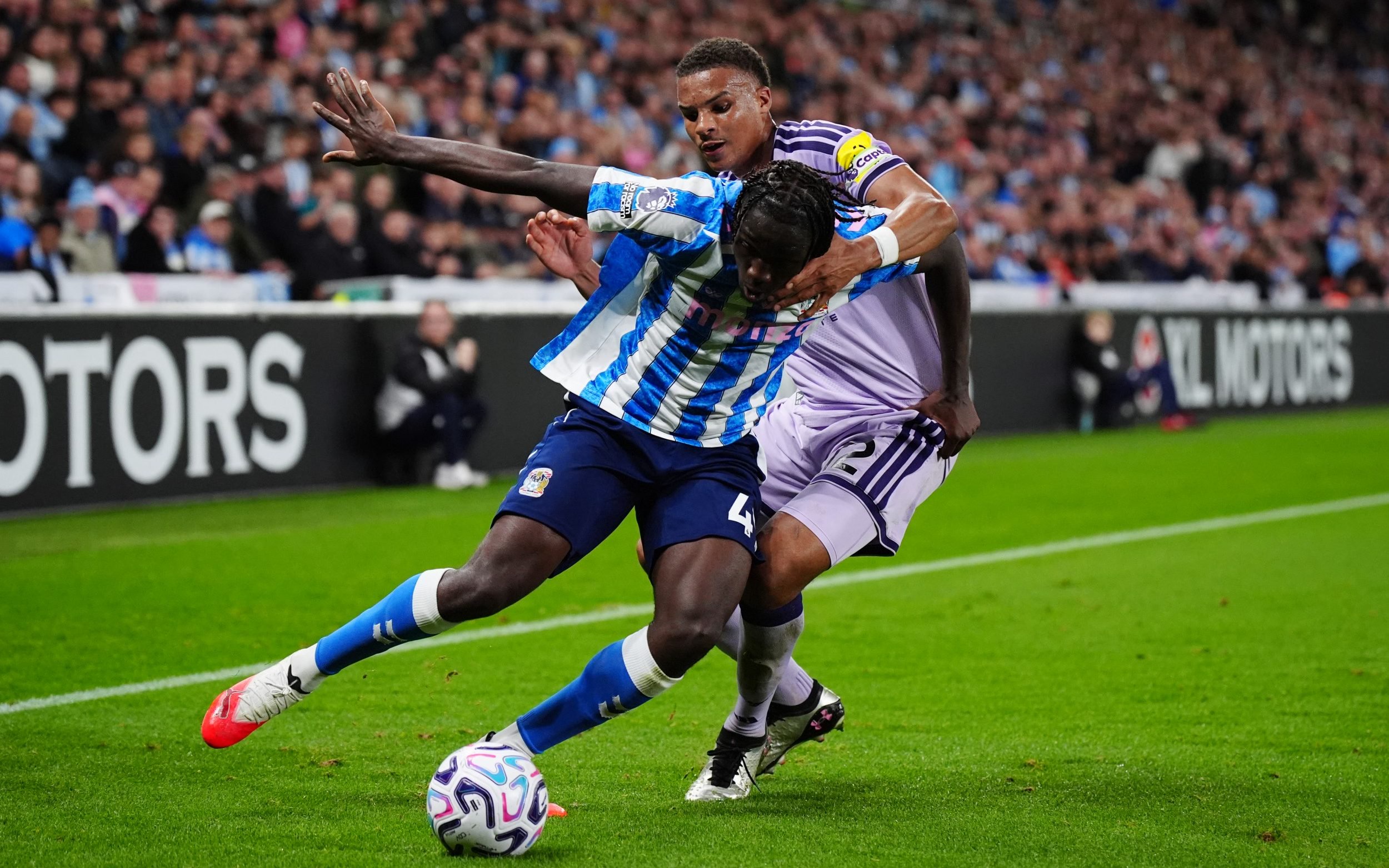 Coventry's Sidiki Cherif and Newcastle United's Malick Thiaw battle for the ball