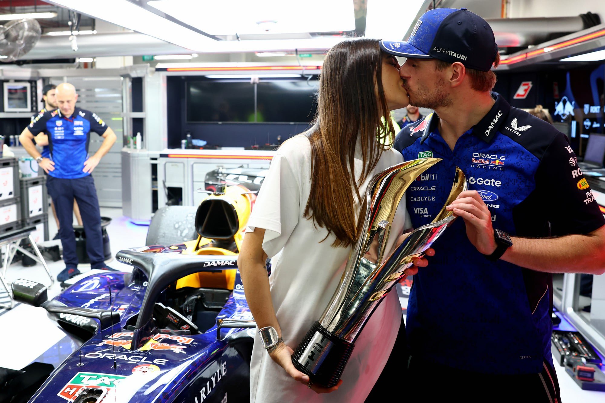 Max Verstappen and Kelly Piquet share a kiss in the Red Bull garage at the Singapore Grand Prix