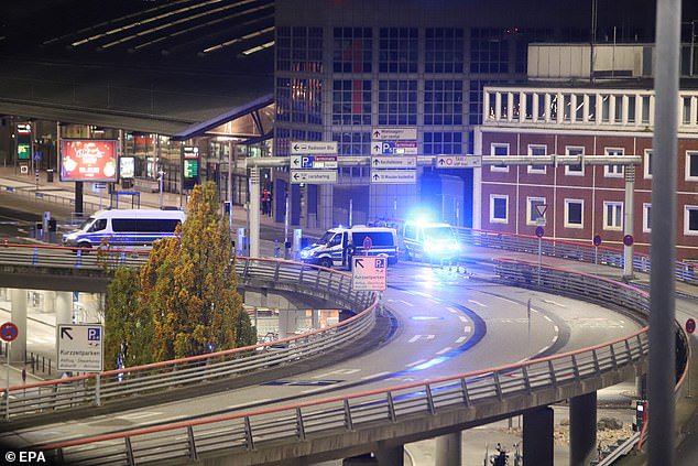 Police vehicles closed off a road leading up to Hamburg Airport following reports of a 'hostage situation' last night