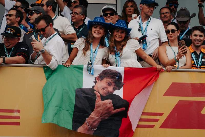 Two young girls hold a flag with Kimi Antonelli's face on it at the 2026 U.S. Grand Prix | These fans knew Kimi Antonelli would win. | Photo by Amber Heckler