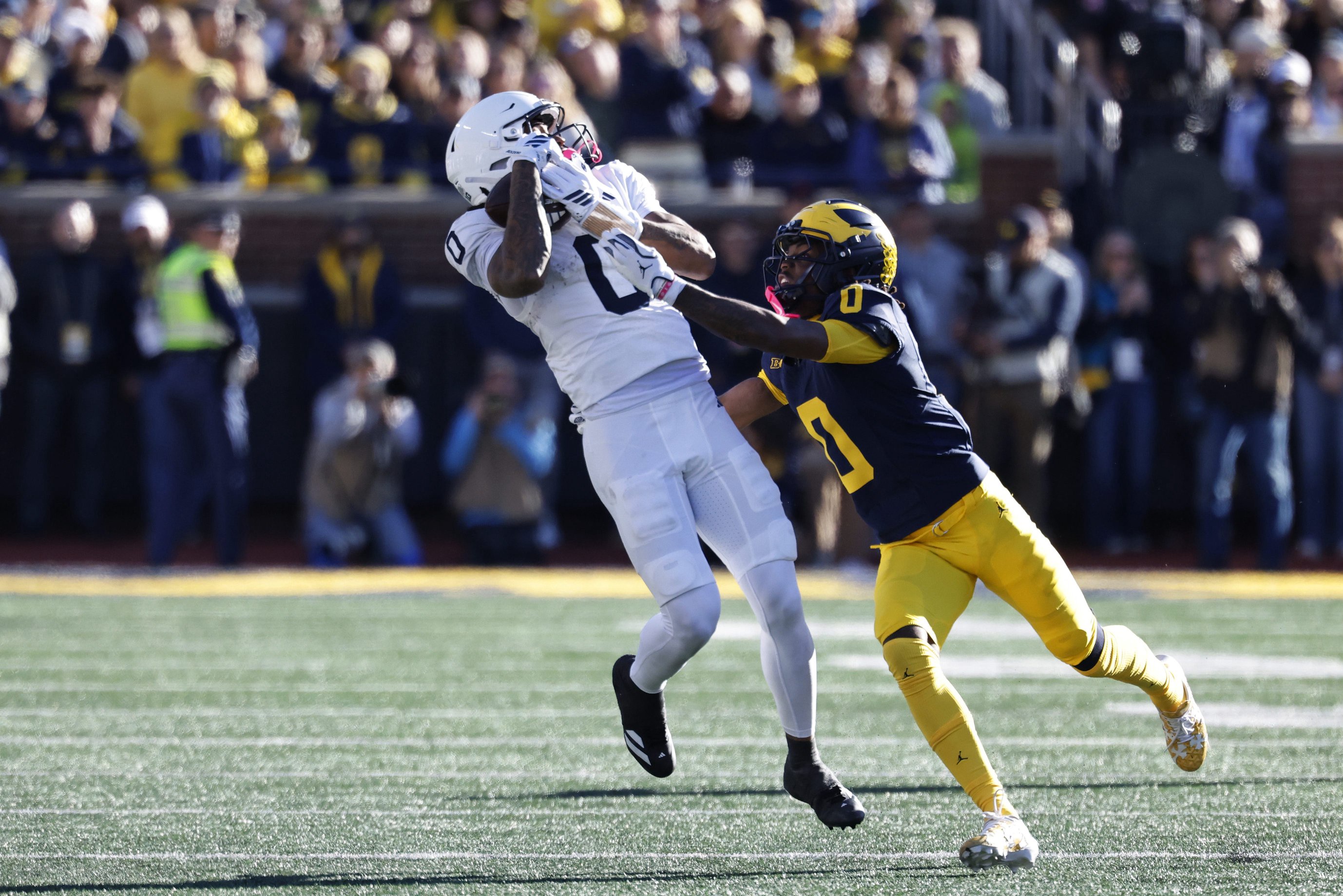 Oct 17, 2026; Ann Arbor, Michigan, USA;  Penn State Nittany Lions wide receiver Chase Sowell (0) makes a catch defended by by Michigan Wolverines defensive back Jyaire Hill (0) in the first half at Michigan Stadium.  Mandatory Credit: Rick Osentoski-Imagn Images