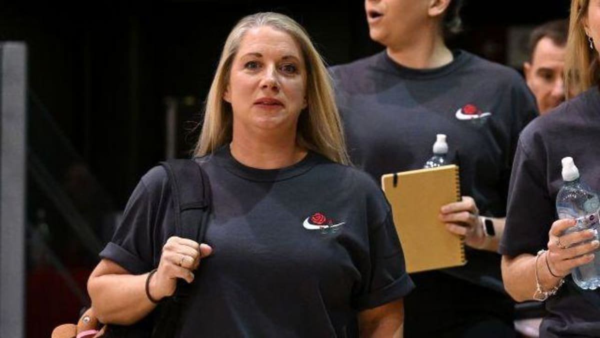 Anna Stembridge in dark blue England Roses T-shirt, with a bag over her right shoulder