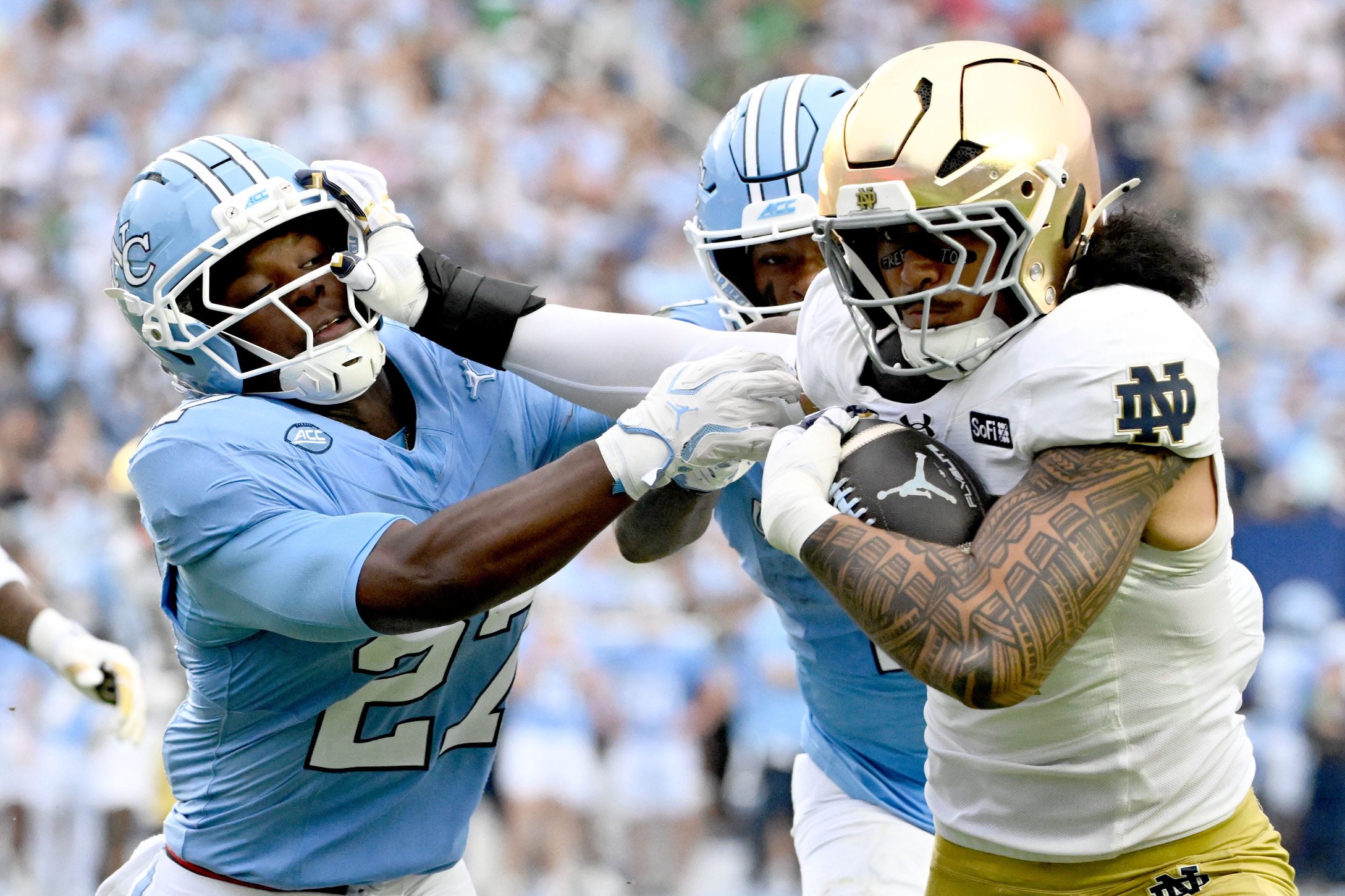 Oct 3, 2026; Chapel Hill, North Carolina, USA; Notre Dame Fighting Irish linebacker Kyngstonn Viliamu-Asa (27) with the ball after intecepting a pass as North Carolina Tar Heels running back Jaylen McGill (27) defends in the first quaret at Kenan Stadium. Mandatory Credit: Bob Donnan-Imagn Images