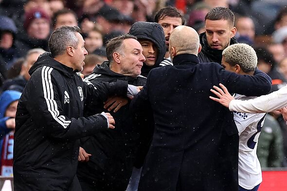 Rico Lewis of Manchester City and Enzo Maresca, Manager of Manchester City, clash with the Aston Villa bench during the Premier 