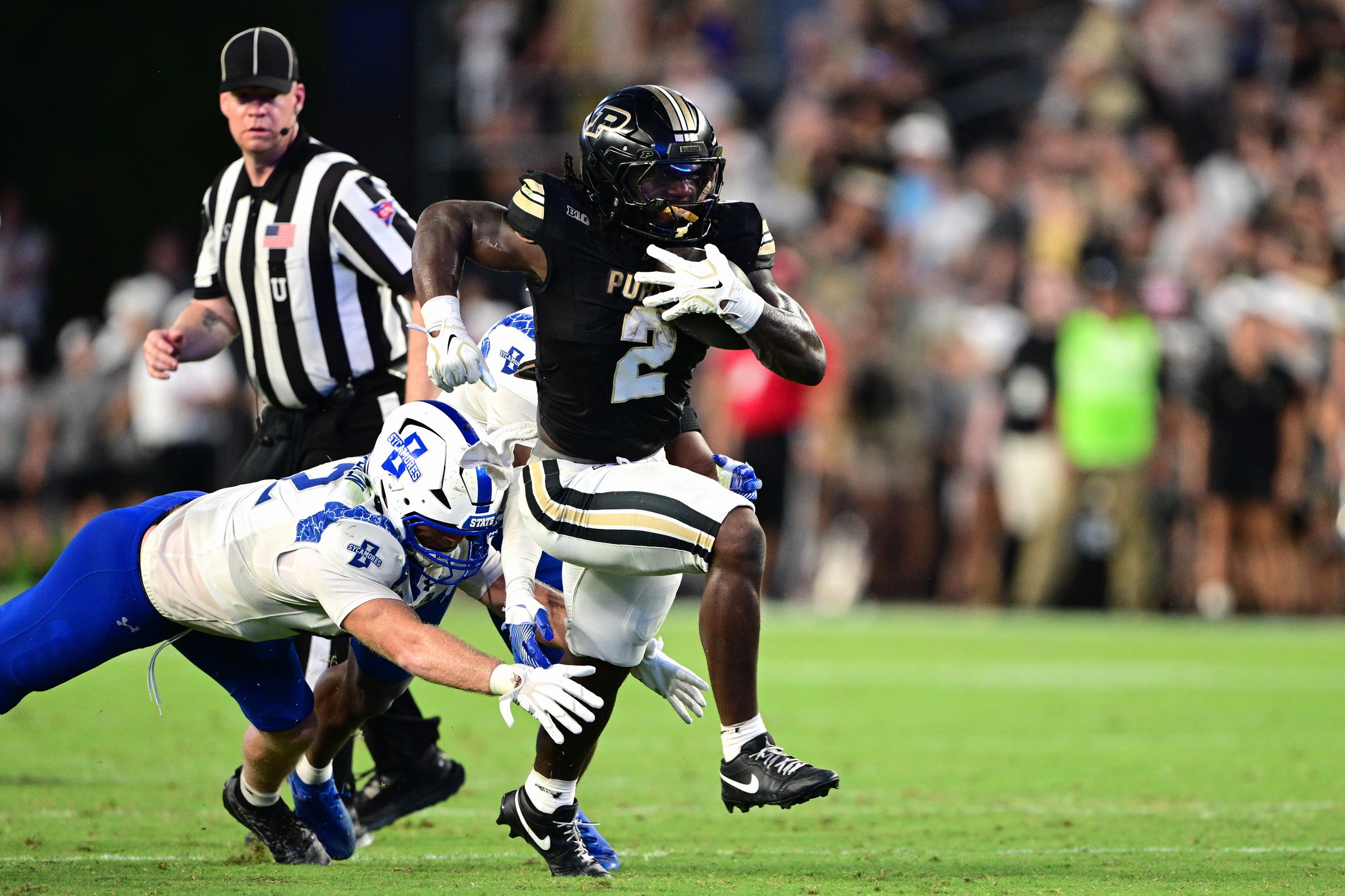 Sep 4, 2026; West Lafayette, Indiana, USA; Purdue Boilermakers running back Fame Ijeboi (2) avoids a tackle by Indiana State Sycamores linebacker Braxton Sampson (42) during the second quarter at Ross-Ade Stadium.