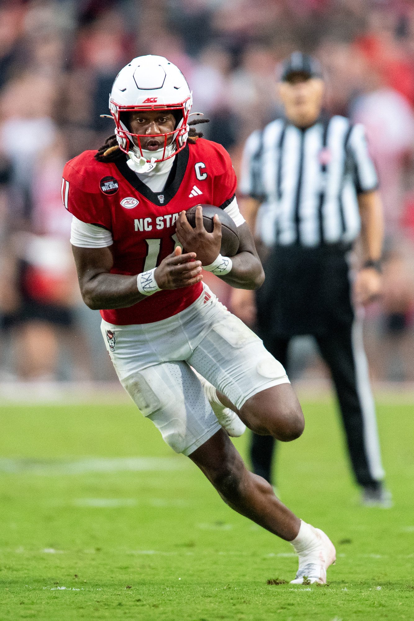 RALEIGH, NORTH CAROLINA - OCTOBER 03: Quarterback CJ Bailey #11 of the NC State Wolfpack scrambles during the second half of the game against the Louisville Cardinals at Carter-Finley Stadium on October 03, 2026 in Raleigh, North Carolina. (Photo by Alex Halloway/Getty Images)
