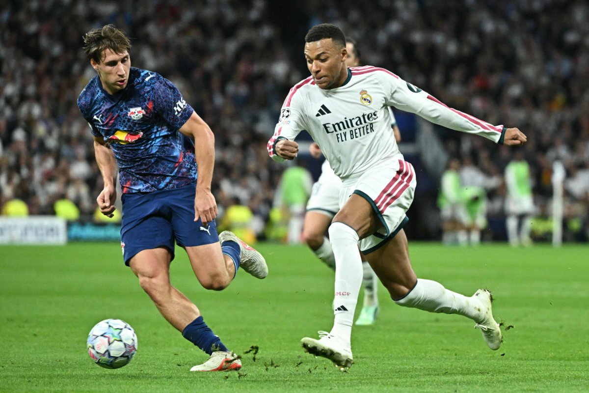 Real Madrid's French forward #10 Kylian Mbappe (R) is challenged by RB Leipzig's Hungarian defender #04 Willi Orban during their UEFA Champions League first round day 3 football match between Real Madrid CF and RB Leipzig at the Santiago Bernabeu stadium in Madrid on October 21, 2026. (AFP)