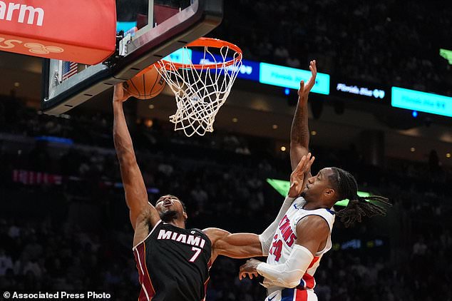 Miami Heat forward Giannis Antetokounmpo (7) scores past Detroit Pistons guard Daniss Jenkins (24) during the second half of an NBA basketball game, Friday, Oct. 23, 2026, in Miami. (AP Photo/Rebecca Blackwell)