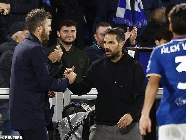 Fabregas shakes hands with embattled Man United boss Michael Carrick after the game