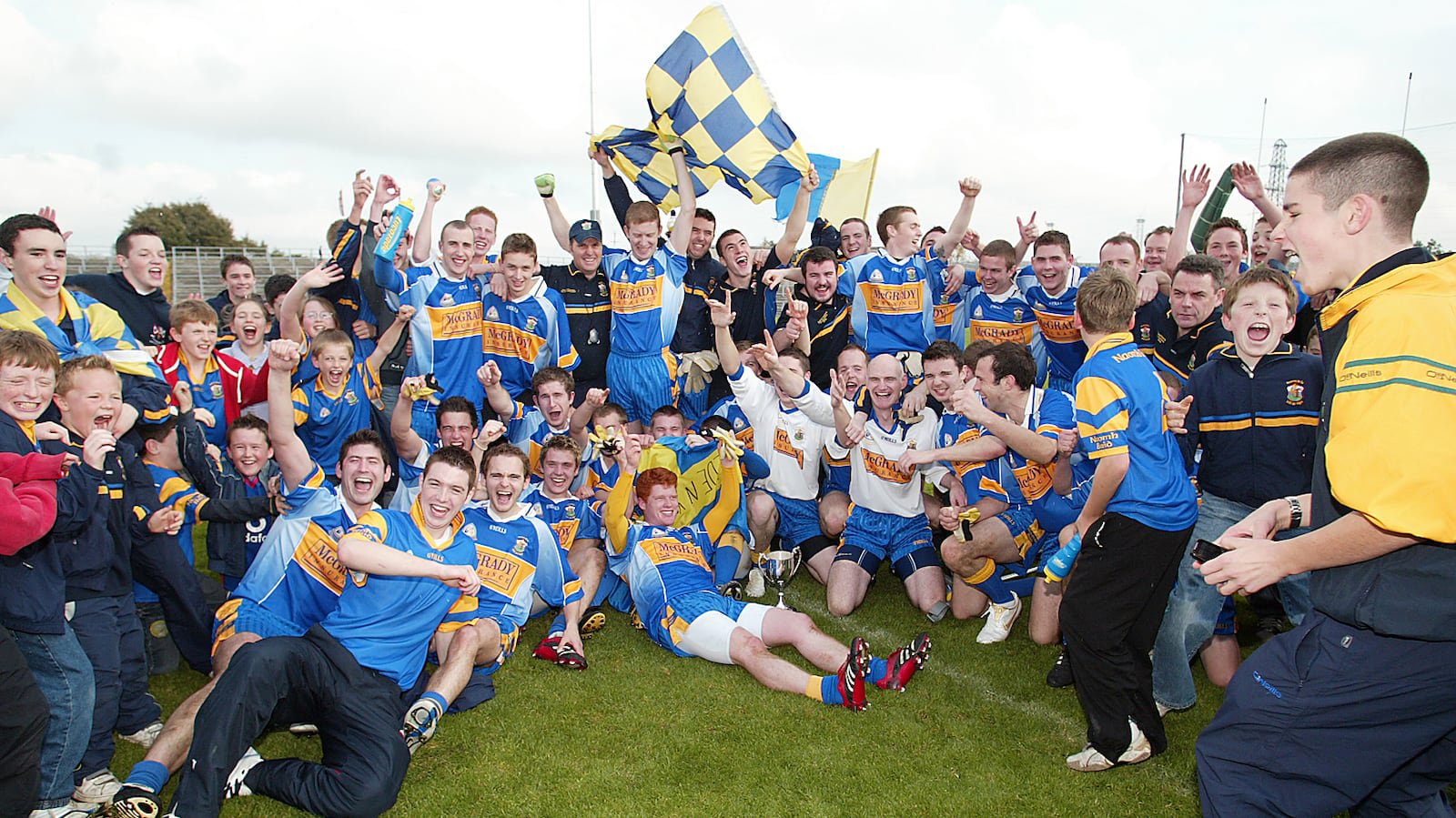 St Brigid's celebrate their 2006 Antrim IFC Final victory over St Ergnat's, Moneyglass in Casement Park. Included in the picture are manager Conor McSherry - and present-day players Ronan McGrady (second from right) and Jack Dowling (furthest right).