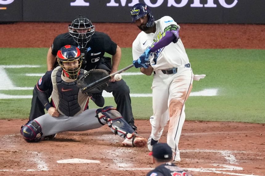 Tampa Bay Rays' Junior Caminero hits a two-run home run against the Guardians that helped seal a trip to the World Series.