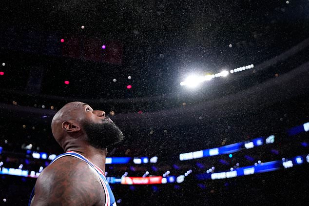 Philadelphia 76ers' LeBron James tosses chalk into the air before an NBA basketball game against the Cleveland Cavaliers Thursday, Oct. 22, 2026, in Philadelphia. (AP Photo/Matt Slocum)
