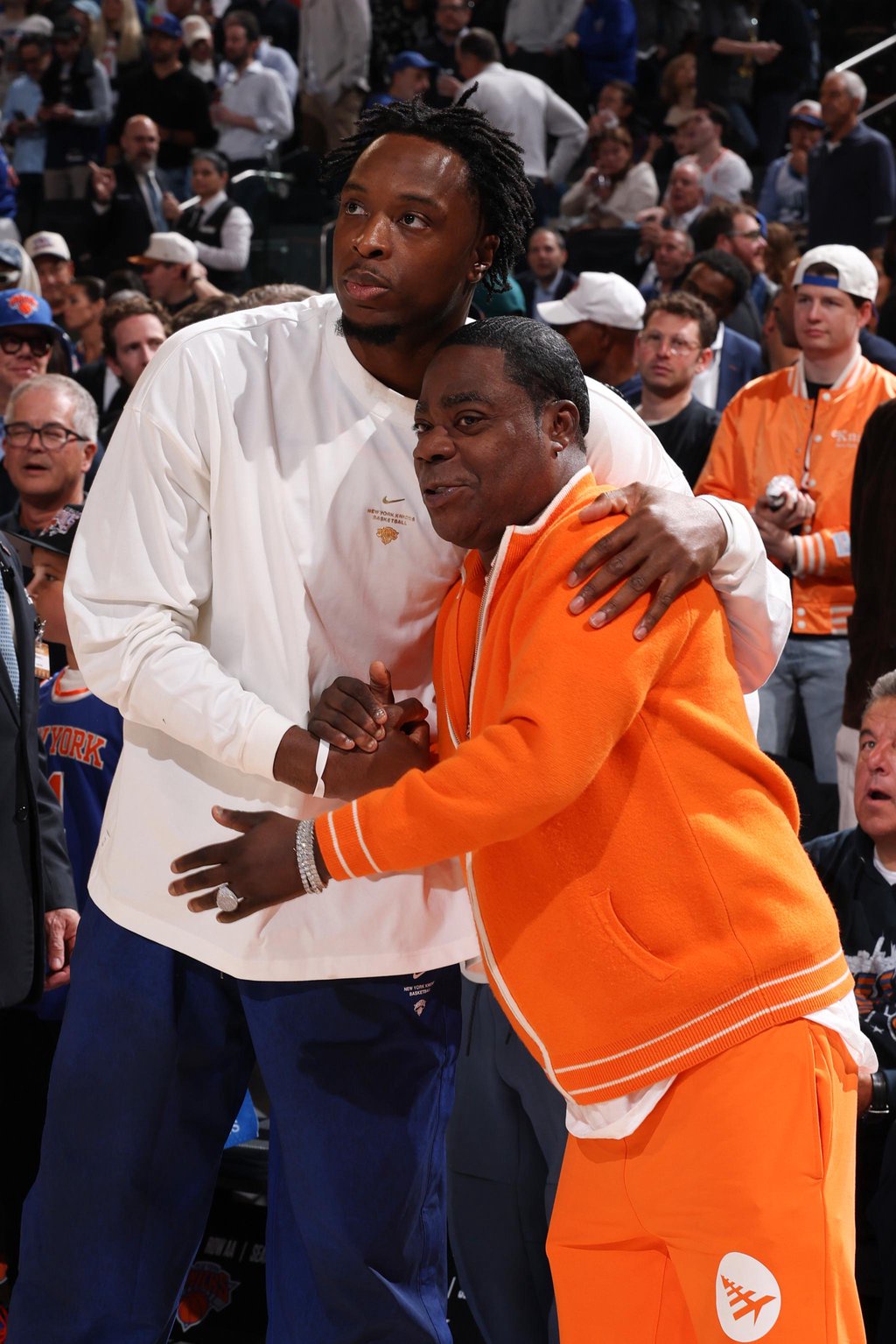 Tracy Morgan and New York Knicks' OG Anunoby hug before an NBA basketball game.