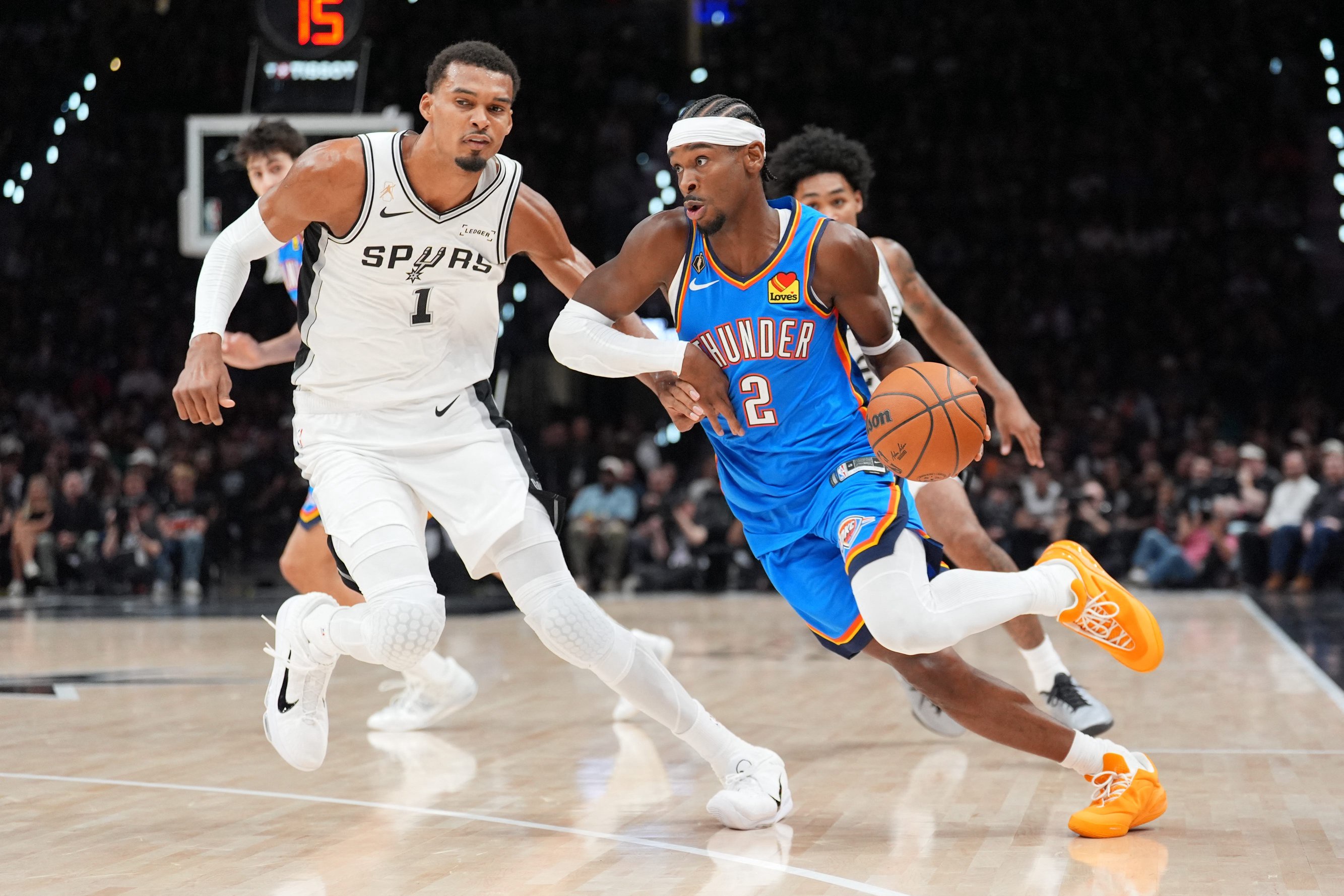 Oct 20, 2026; San Antonio, Texas, USA;  Oklahoma City Thunder guard Shai Gilgeous-Alexander (2) dribbles against San Antonio Spurs forward Victor Wembanyama (1) in the first half at Frost Bank Center.  Mandatory Credit: Daniel Dunn-Imagn Images