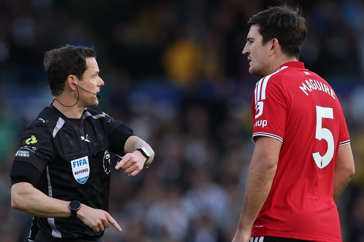 Referee Darren England speaks with Harry Maguire during Manchester United's draw with Leeds United