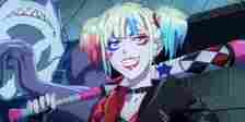 Suicide Squad Isekai Trailer of Harley Quinn smirking playfully while holding a bat