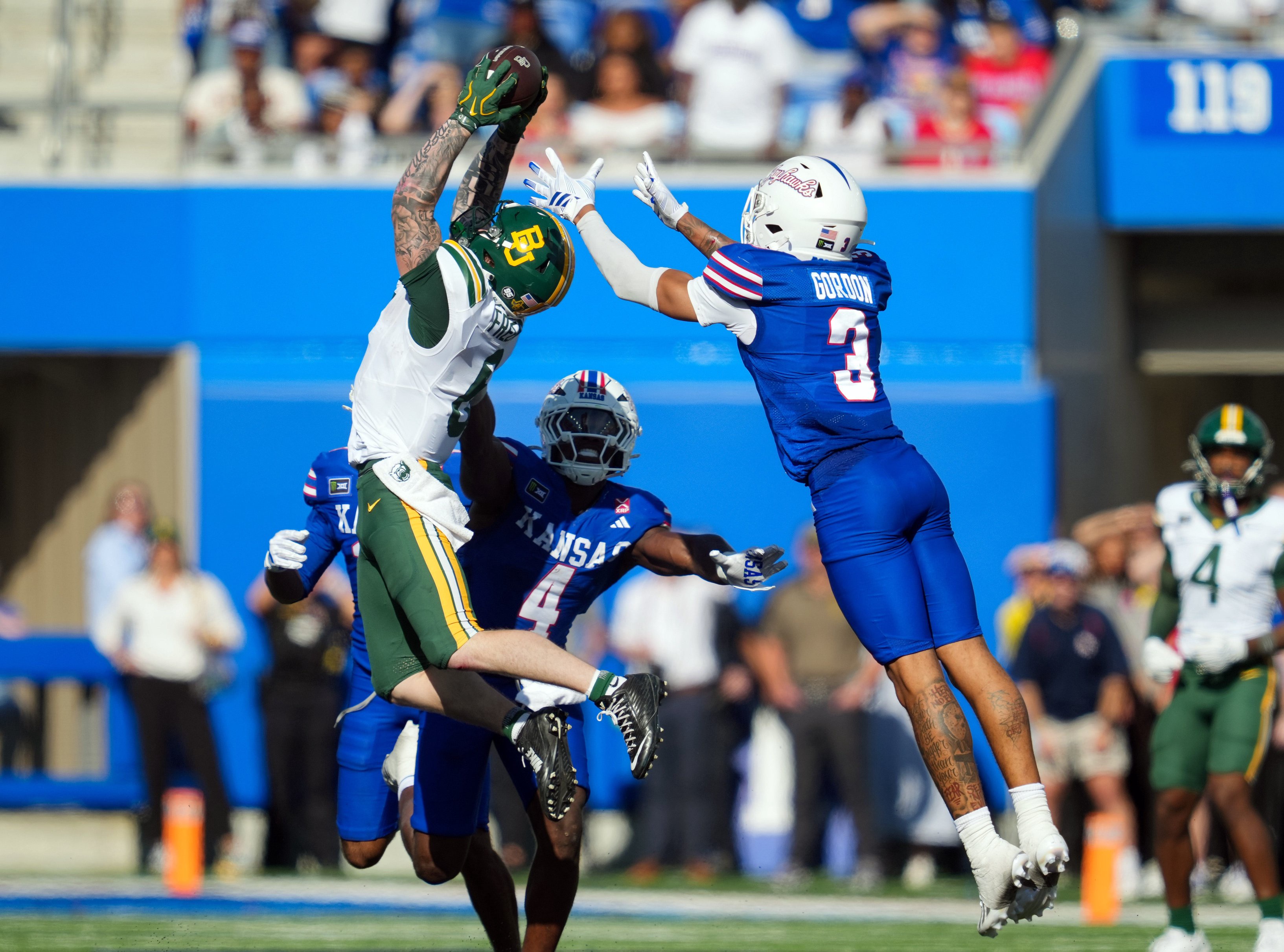 Oct 24, 2026; Lawrence, Kansas, USA; Baylor Bears wide receiver Gavin Freeman (6) catches a pass against Kansas Jayhawks linebacker Trey Lathan (4) and safety Corey Gordon (3) during the second half  at David Booth Kansas Memorial Stadium. Mandatory Credit: Jay Biggerstaff-Imagn Images