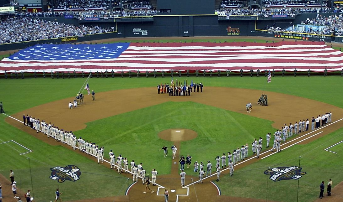 Members of the US armed forces display a giant American flag during ceremonies before Game 1 of the 2001 World Series.