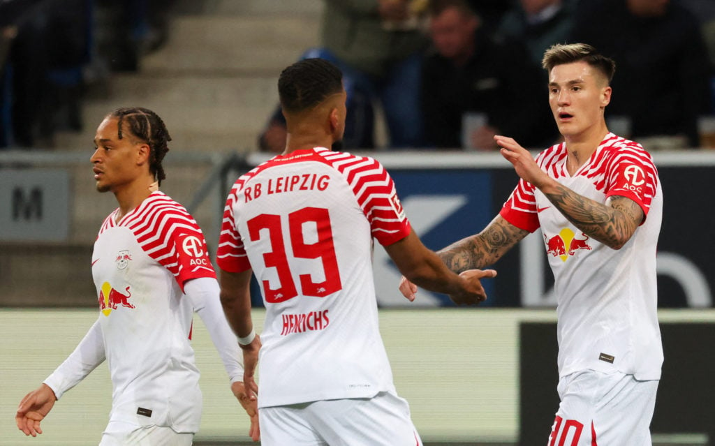 Leipzig's Slovenian forward #30 Benjamin Sesko (R) celebrates scoring his team's first goal with team mates Leipzig's German defender #39 Benjamin ...