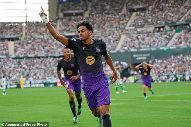 Barcelona's Lamine Yamal celebrates after scoring his side's opening goal during the Spanish La Liga soccer match between Real Betis and Barcelona in Seville, Spain, Saturday, Oct. 17, 2026. (AP Photo/Jose Breton)