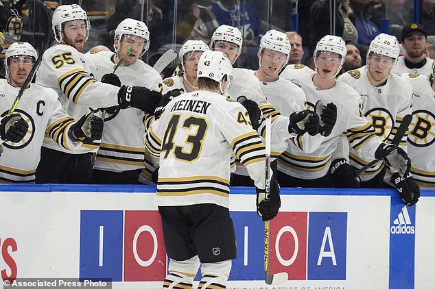 Boston Bruins left wing Danton Heinen (43) celebrates with the bench after his goal against the Tampa Bay Lightning during the first period of an NHL hockey game Wednesday, March 27, 2024, in Tampa, Fla. (AP Photo/Chris O'Meara)