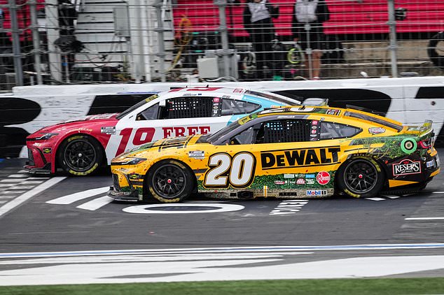 Chase Briscoe (19) beats Christopher Bell (20) to the finish line to win a NASCAR Cup Series auto race, Sunday, Oct. 11, 2026, in Concord, N.C. (AP Photo/Matt Kelley)