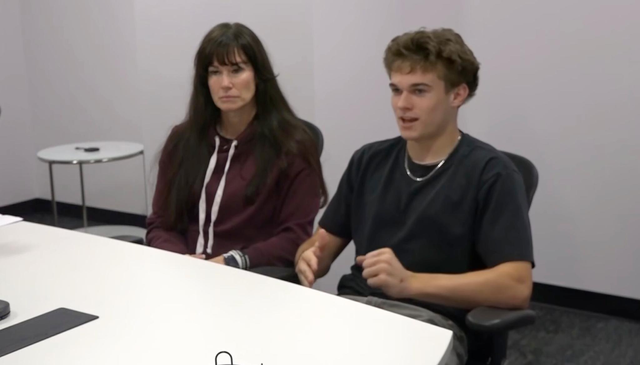 Desert Ridge High School senior quarterback Gunner Brewer and a woman are seated at a table.