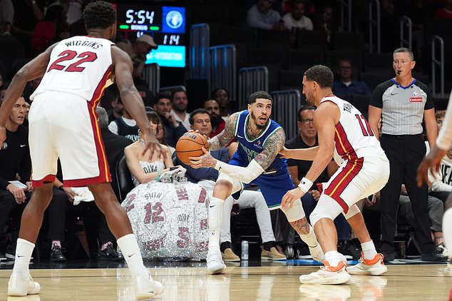 Minnesota Timberwolves guard LaMelo Ball (1) looks for an opening defended by Miami Heat guard Klay Thompson (11) during the second half of an NBA basketball game, Wednesday, Oct. 21, 2026, in Miami. (AP Photo/Rebecca Blackwell)