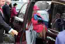 Queen Elizabeth appears to quickly cover her legs with a blanket when her car door is opened