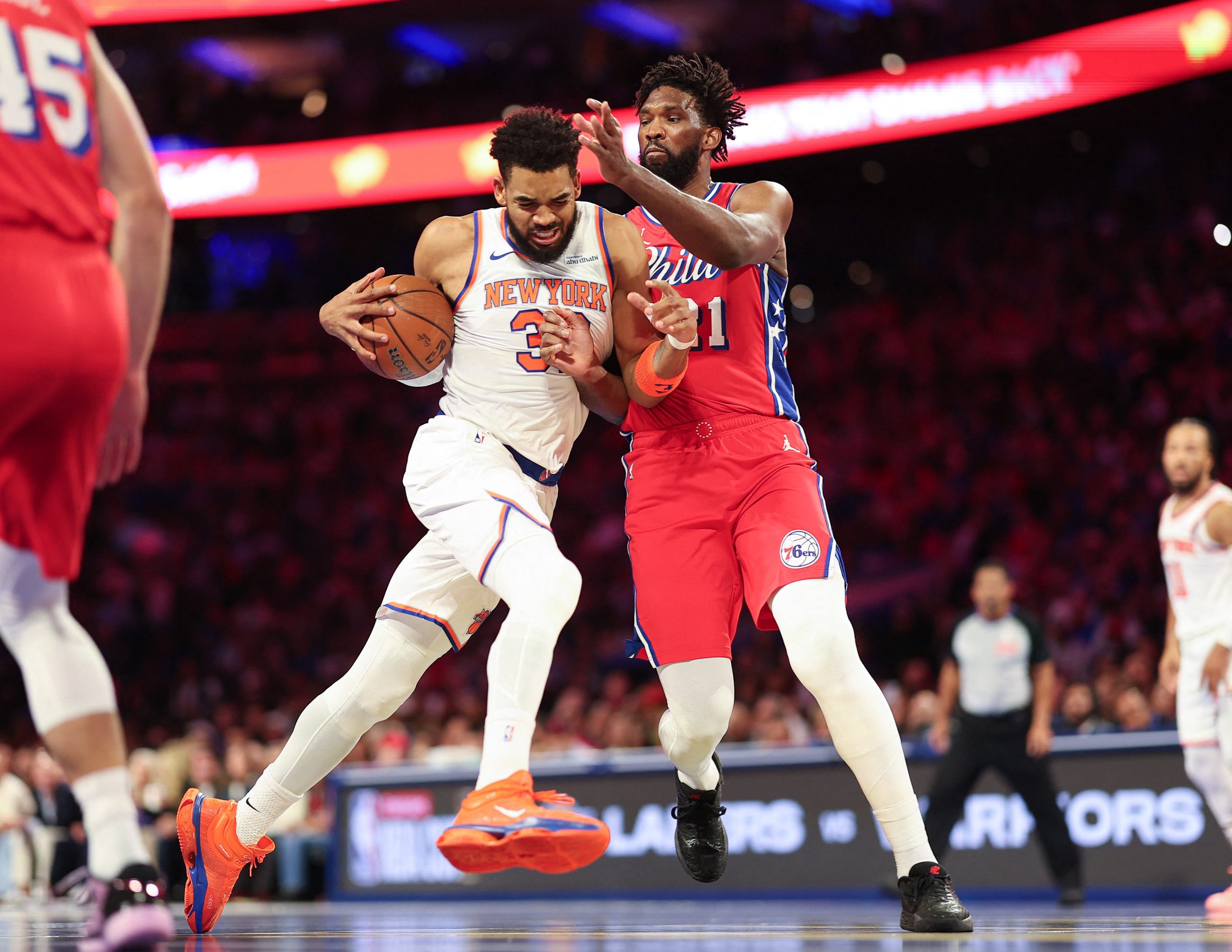 Oct 30, 2026; Philadelphia, Pennsylvania, USA; New York Knicks center Karl-Anthony Towns (32) drives against Philadelphia 76ers center Joel Embiid (21) during the first quarter at Xfinity Mobile Arena. Mandatory Credit: Bill Streicher-Imagn Images