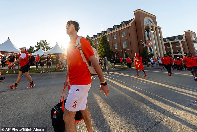 Oklahoma State quarterback Drew Mestemaker (17) walks to the stadium before a game