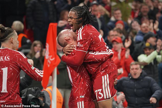 Liverpool's Alexis Mac Allister, centre, celebrates with Liverpool's Rio Ngumoha after scoring his side's third goal during the Champions League opening phase soccer match between Liverpool and Villarreal in Liverpool, England, Tuesday, Oct. 20, 2026. (AP Photo/Ian Hodgson)