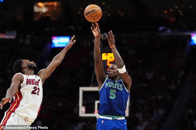 Minnesota Timberwolves guard Anthony Edwards (5) shoots past Miami Heat forward Andrew Wiggins (22) during the second half of an NBA basketball game, Wednesday, Oct. 21, 2026, in Miami. (AP Photo/Rebecca Blackwell)